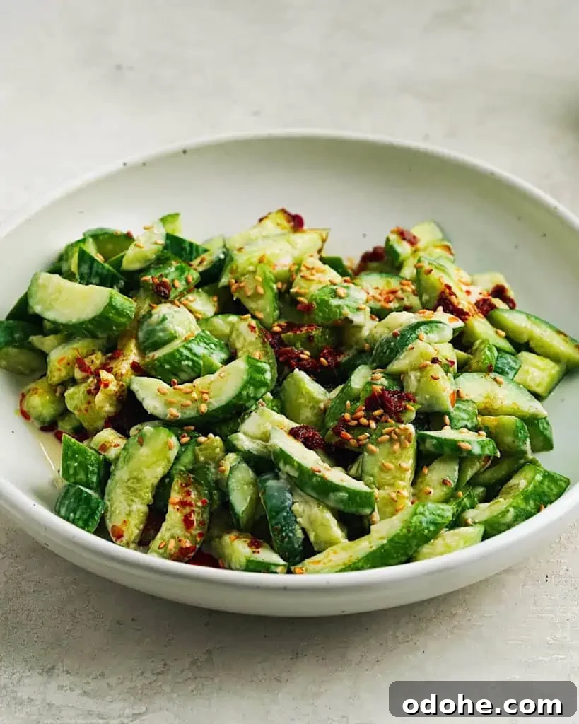 smashed cucumber salad Smashed Cucumber Salad with Tahini Miso Dressing, topped with sesame seeds, and chili oil