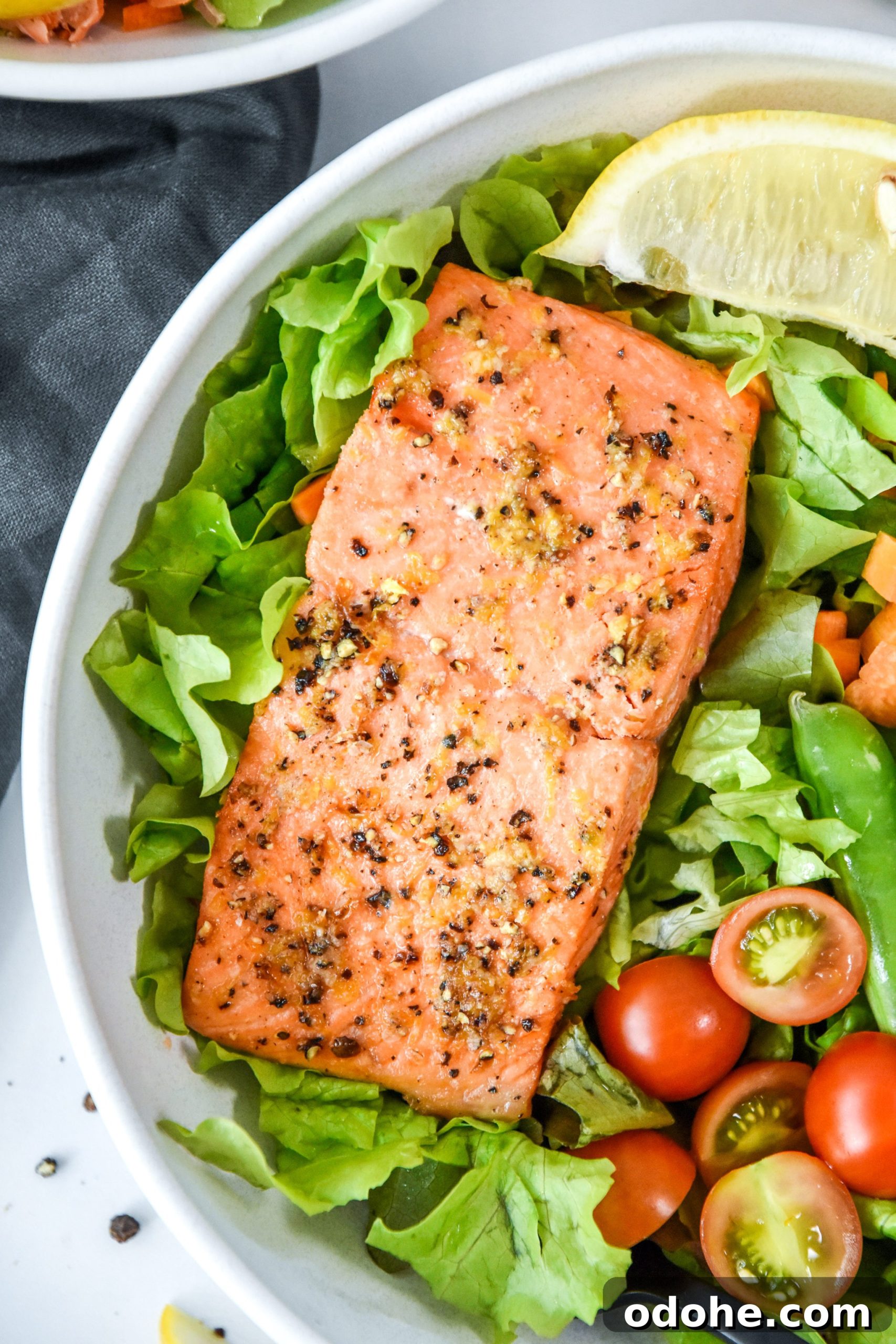 air fryer lemon pepper salmon on a salad.