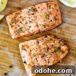 air fryer lemon pepper salmon filets on a cutting board.