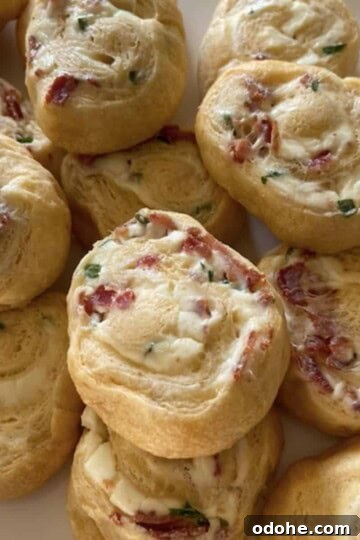 bacon cream cheese crescent rolls stacked on white plate