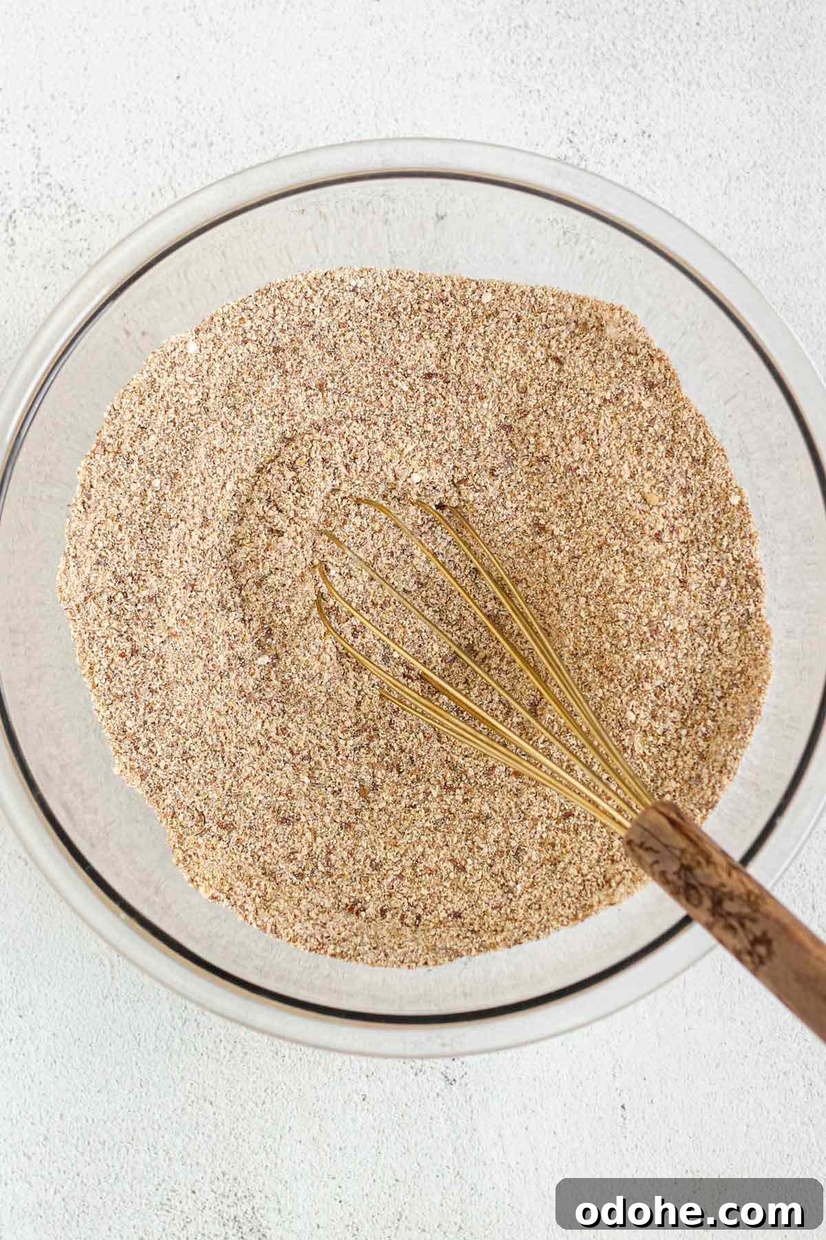 Flaxseed Carrot Muffins with Cinnamon and Honey 4 Dry ingredients for flaxseed carrot muffins mixed in a glass mixing bowl.