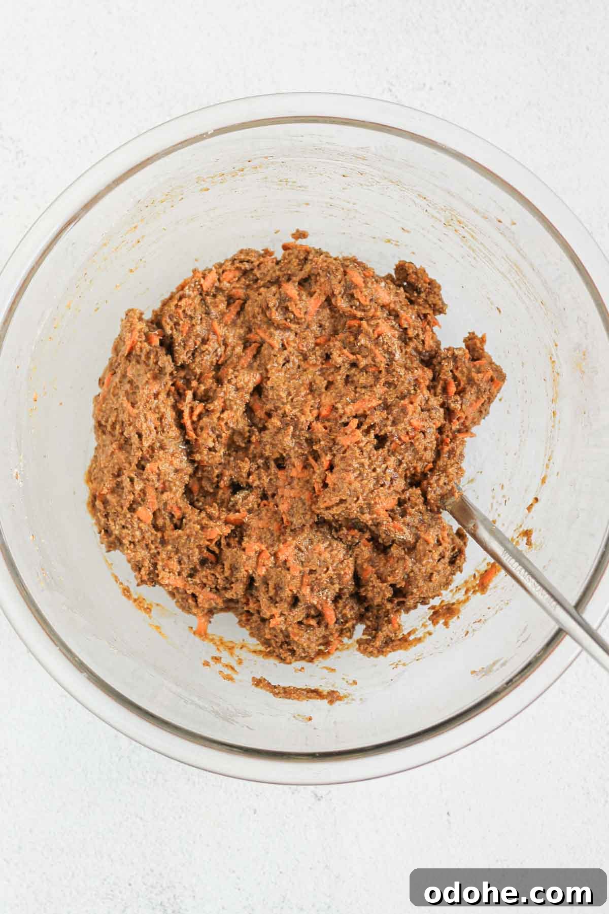 Flaxseed Carrot Muffins with Cinnamon and Honey 6 Fully mixed batter for carrot flaxseed muffins in a glass mixing bowl.
