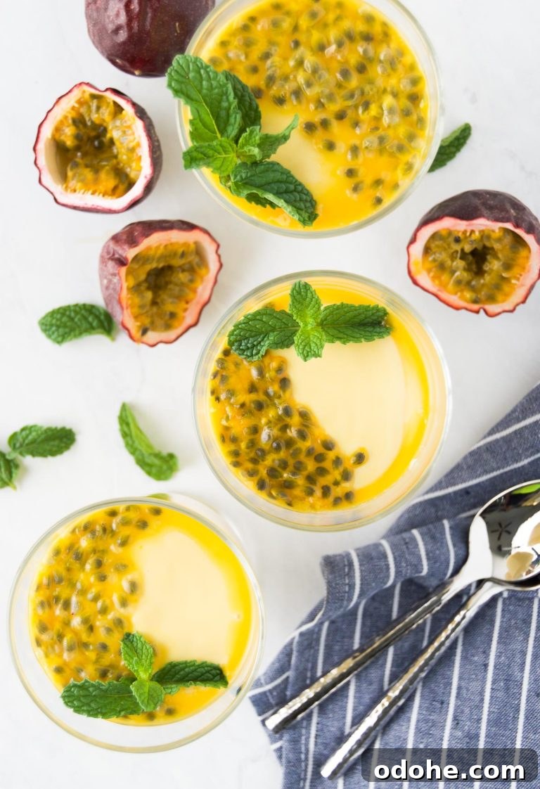 Two small containers of passion fruit mousse with mint and seed garnishes