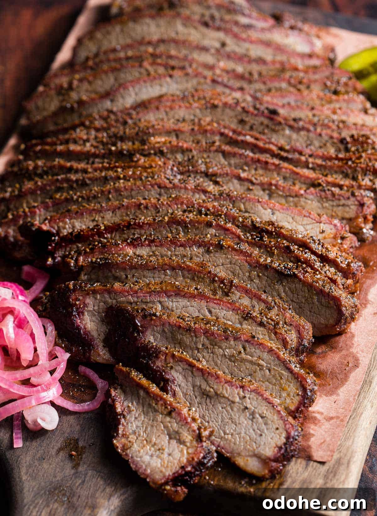 Smoking a Brisket Flat: Step-by-Step Guide for Tender Results 9 Slices of smoked brisket flat on a platter with garnishes