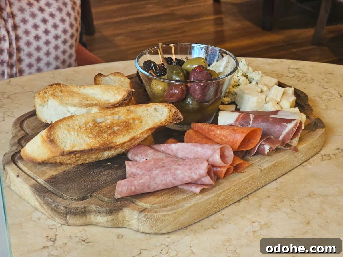 Charcuterie board with meat, cheese and bread