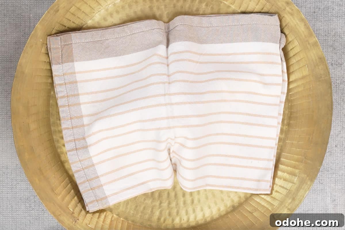 Dough covered with a kitchen towel.