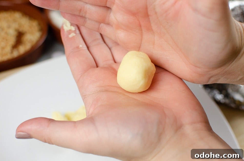 Decadent White Chocolate Truffles Recipe for Homemade Gifts 9 Rolling the white chocolate truffle by hand into a ball
