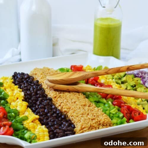 white platter with rows of vegetables for cowboy rice salad