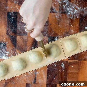 Fresh Spinach and Ricotta Ravioli Recipe for Homemade Pasta 13 Filled ravioli being cut with a fluted roller.