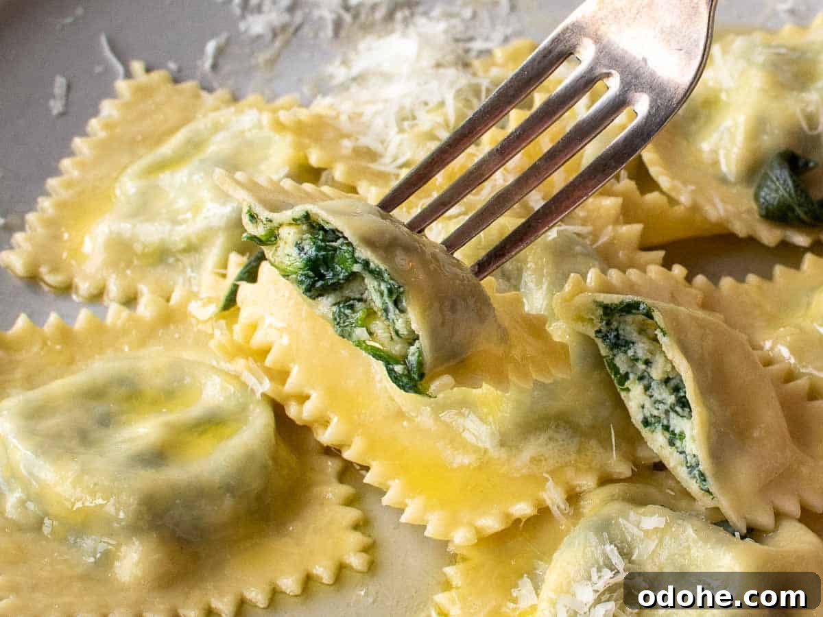 Fresh Spinach and Ricotta Ravioli Recipe for Homemade Pasta 17 Spinach ravioli with ricotta on a fork cut in half with more on a plate.