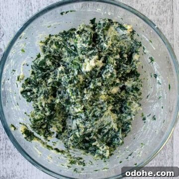 Fresh Spinach and Ricotta Ravioli Recipe for Homemade Pasta 5 Overhead view of spinach and ricotta filling in a clear glass bowl.