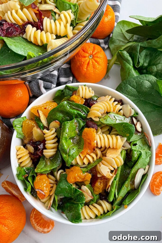 Mandarin Spinach Pasta Salad with Citrus Vinaigrette 2 mandarin spinach pasta salad in a serving bowl with oranges on the side