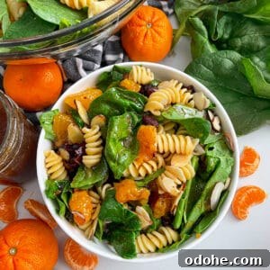 Mandarin Spinach Pasta Salad with Citrus Vinaigrette 5 mandarin spinach pasta salad in a serving bowl with oranges and spinach on the side