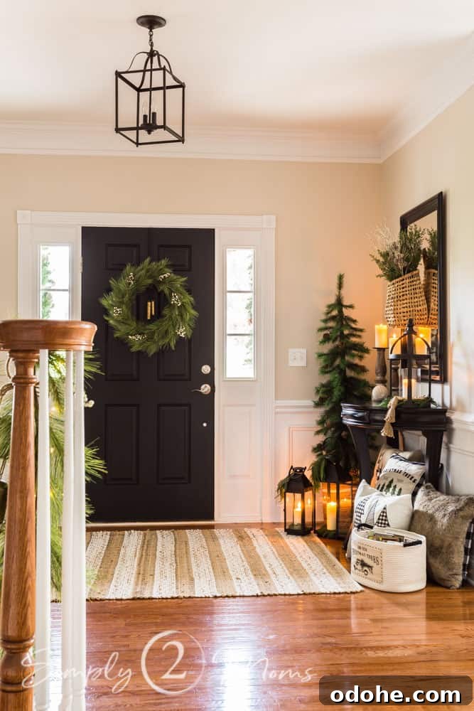 13 Timeless Neutral Christmas Decorating Ideas for Your Home 11 foyer decorated for christmas front door wreath and christmas tree beside table
