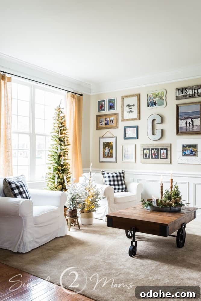 13 Timeless Neutral Christmas Decorating Ideas for Your Home 14 two chairs in front of window with trio of small Christmas trees between them