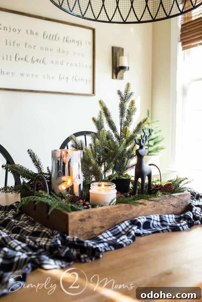 13 Timeless Neutral Christmas Decorating Ideas for Your Home 15 wood tray on plaid table runner in middle of kitchen table decorated with greenery and candles