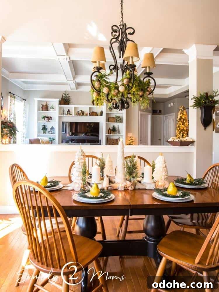 13 Timeless Neutral Christmas Decorating Ideas for Your Home 18 Cherry and black kitchen table decorated for Christmas with cream trees and pears