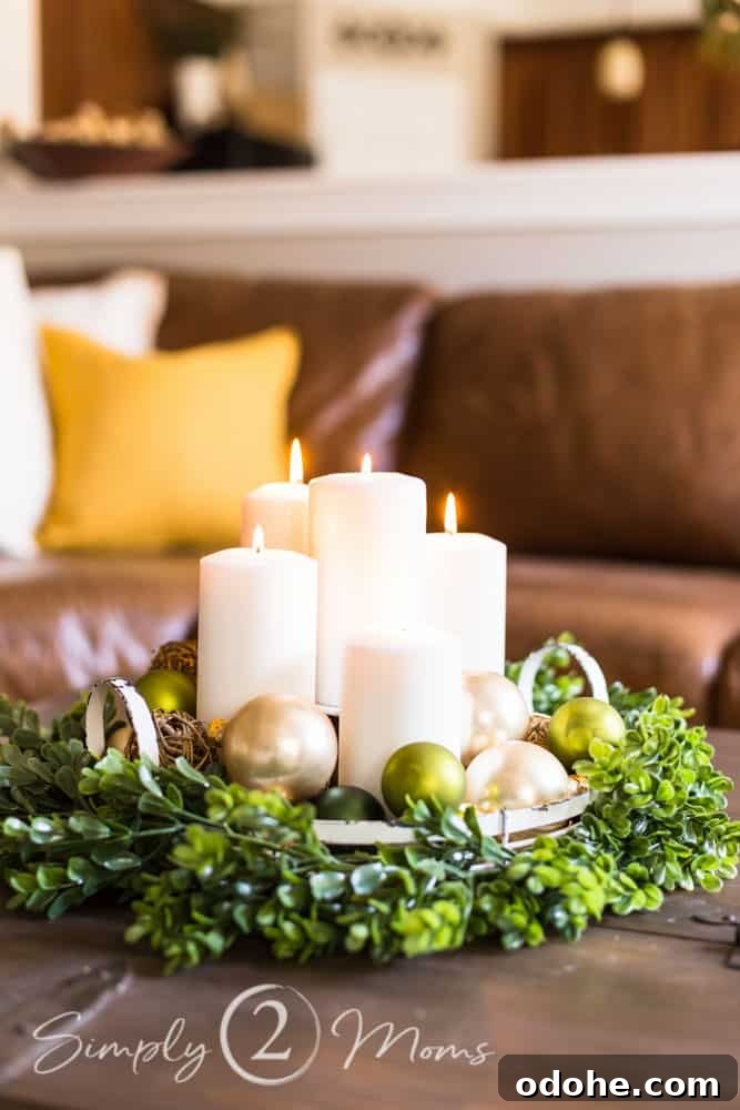 13 Timeless Neutral Christmas Decorating Ideas for Your Home 8 Round white metal tray with handles surrounded by a boxwood garland and filled with white pillar candles and gold ornaments.