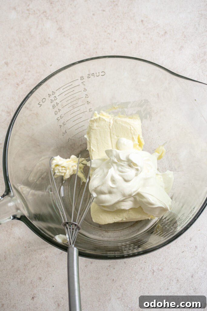 The start of making the topping with sour cream and softened cream cheese.