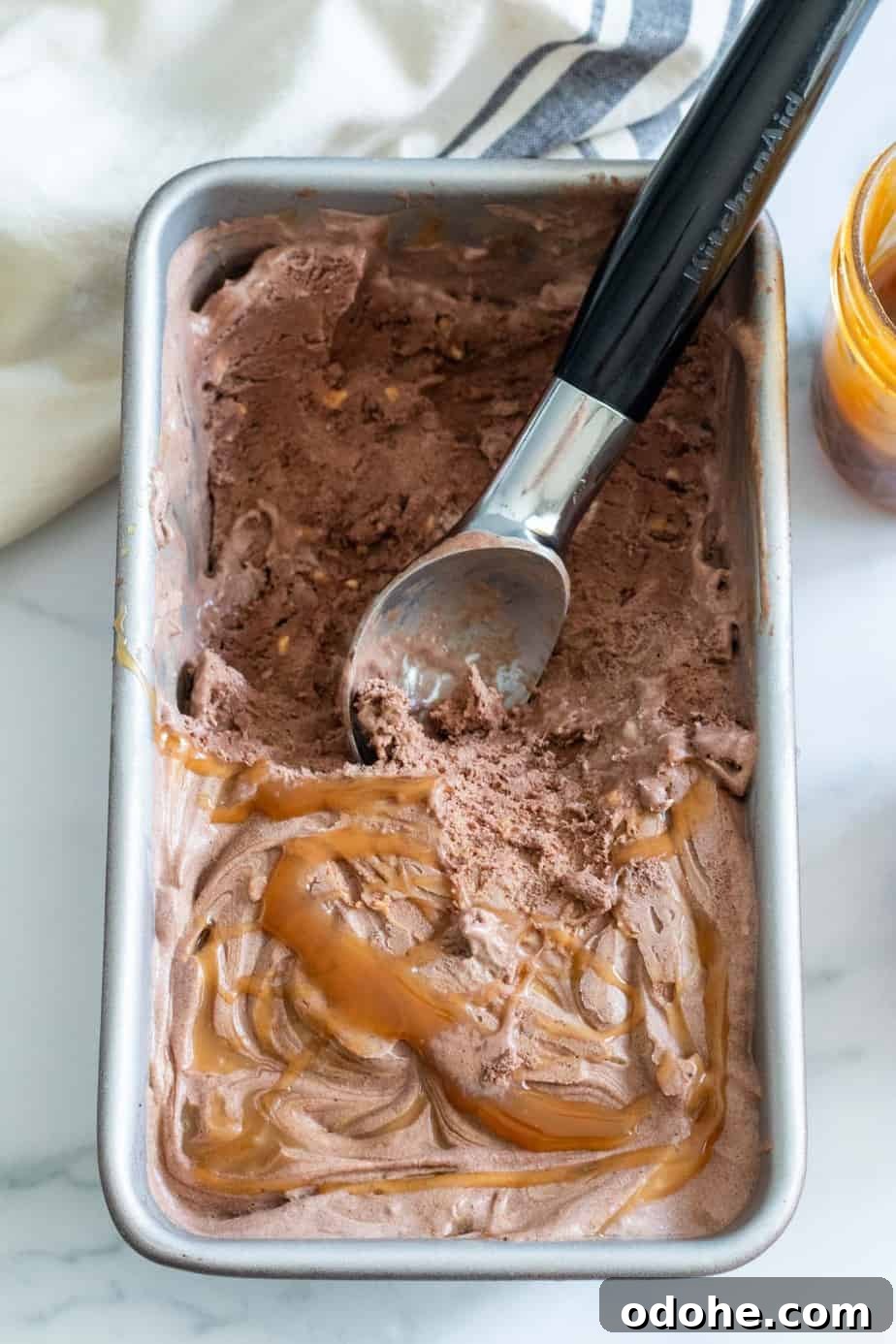 loaf pan of chocolate ice cream with caramel drizzle