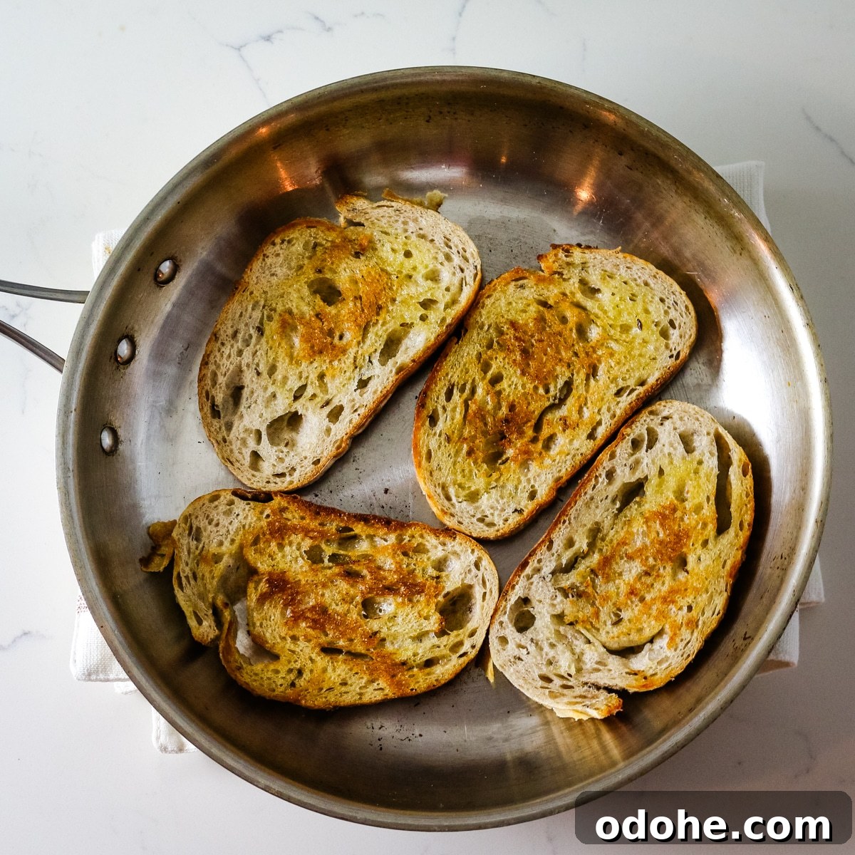 Sardine and Egg Toast Recipe for Brunch or Quick Meals 7 Four pieces of bread in a pan.