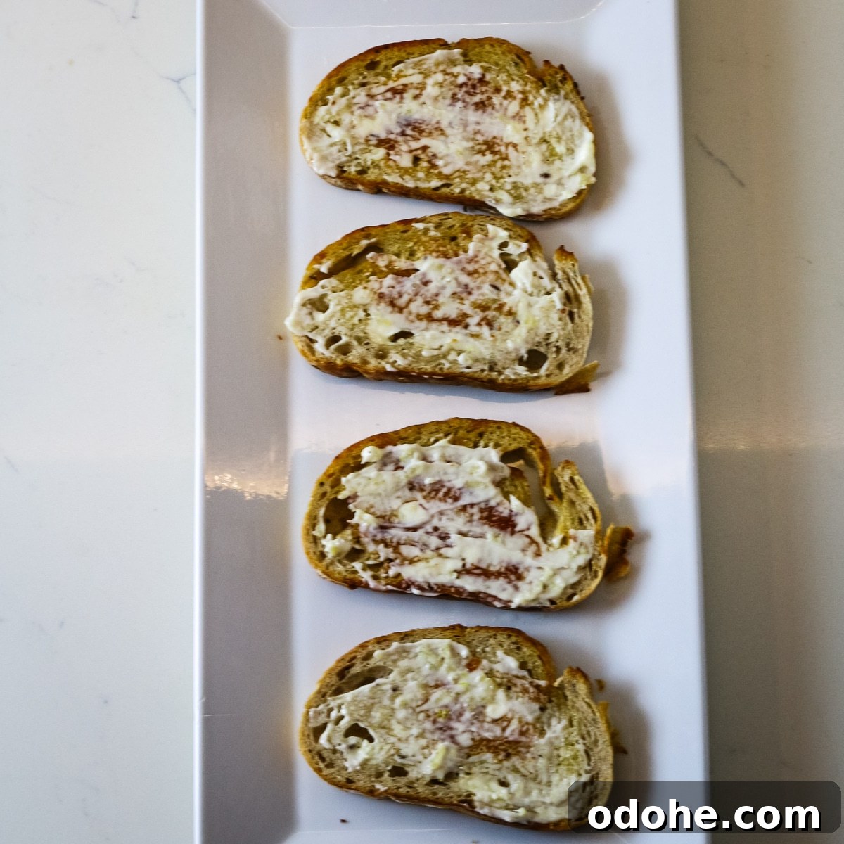 Sardine and Egg Toast Recipe for Brunch or Quick Meals 9 Four pieces of bread with spread on a white plate.