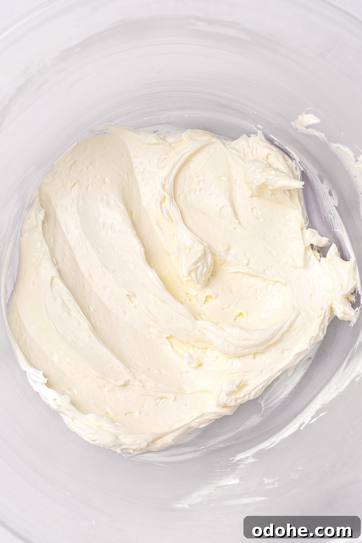 butter whipped for white chocolate buttercream frosting in mixing bowl