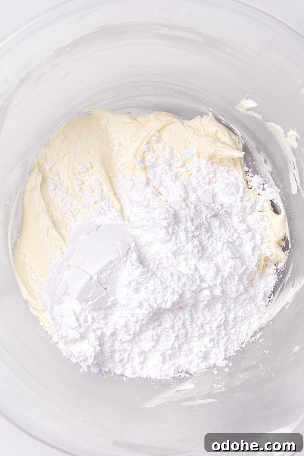 butter and powdered sugar mixed for white chocolate buttercream frosting