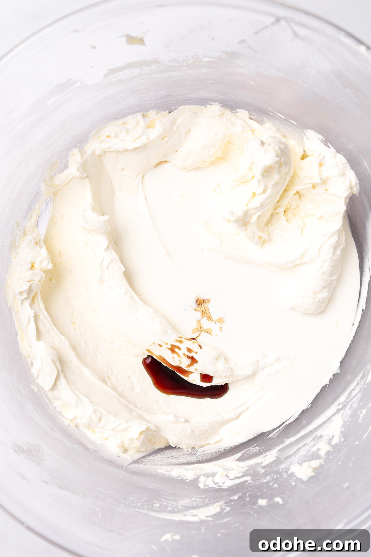 white chocolate buttercream frosting with cream and vanilla in bowl