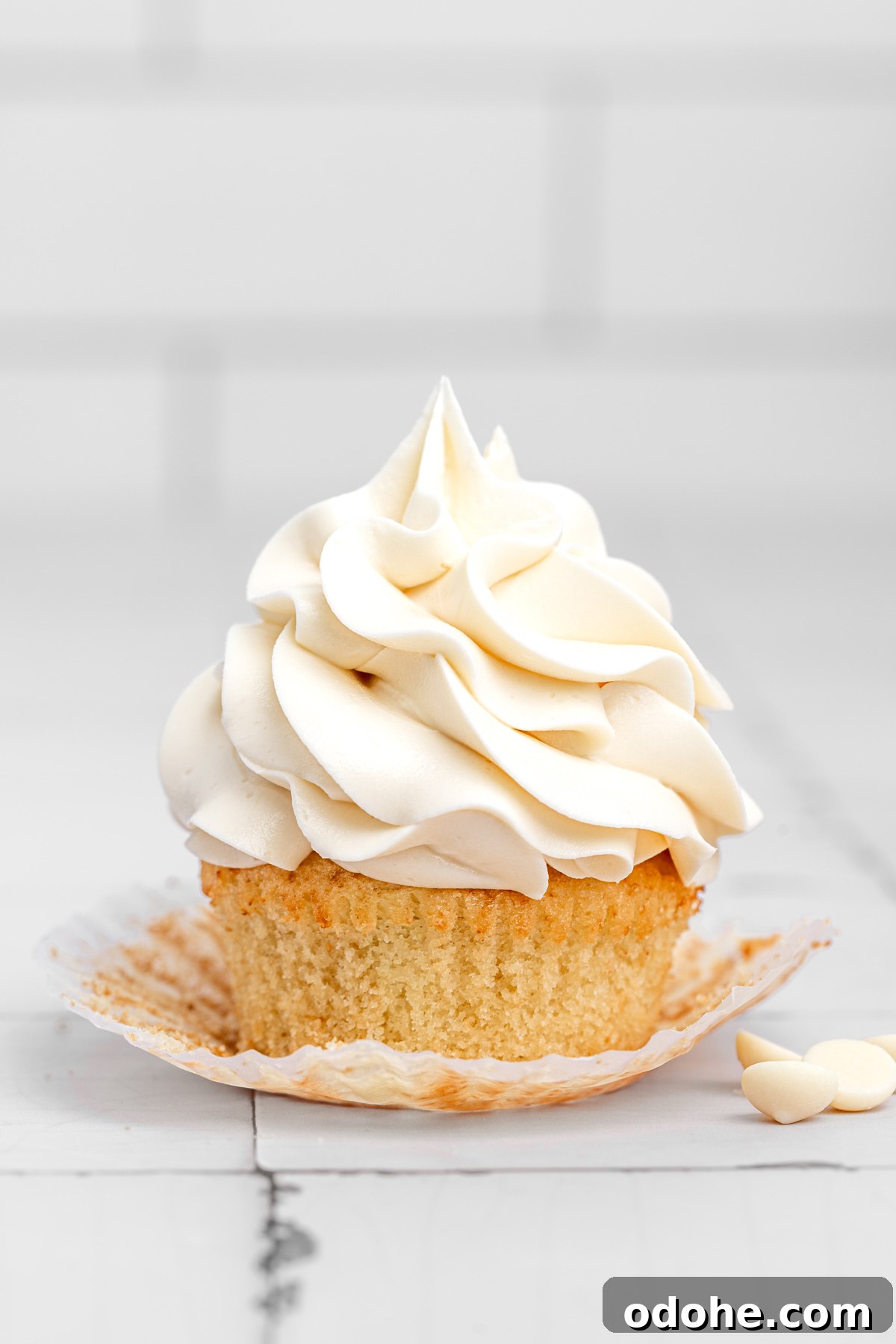 cupcake topped with white chocolate buttercream frosting