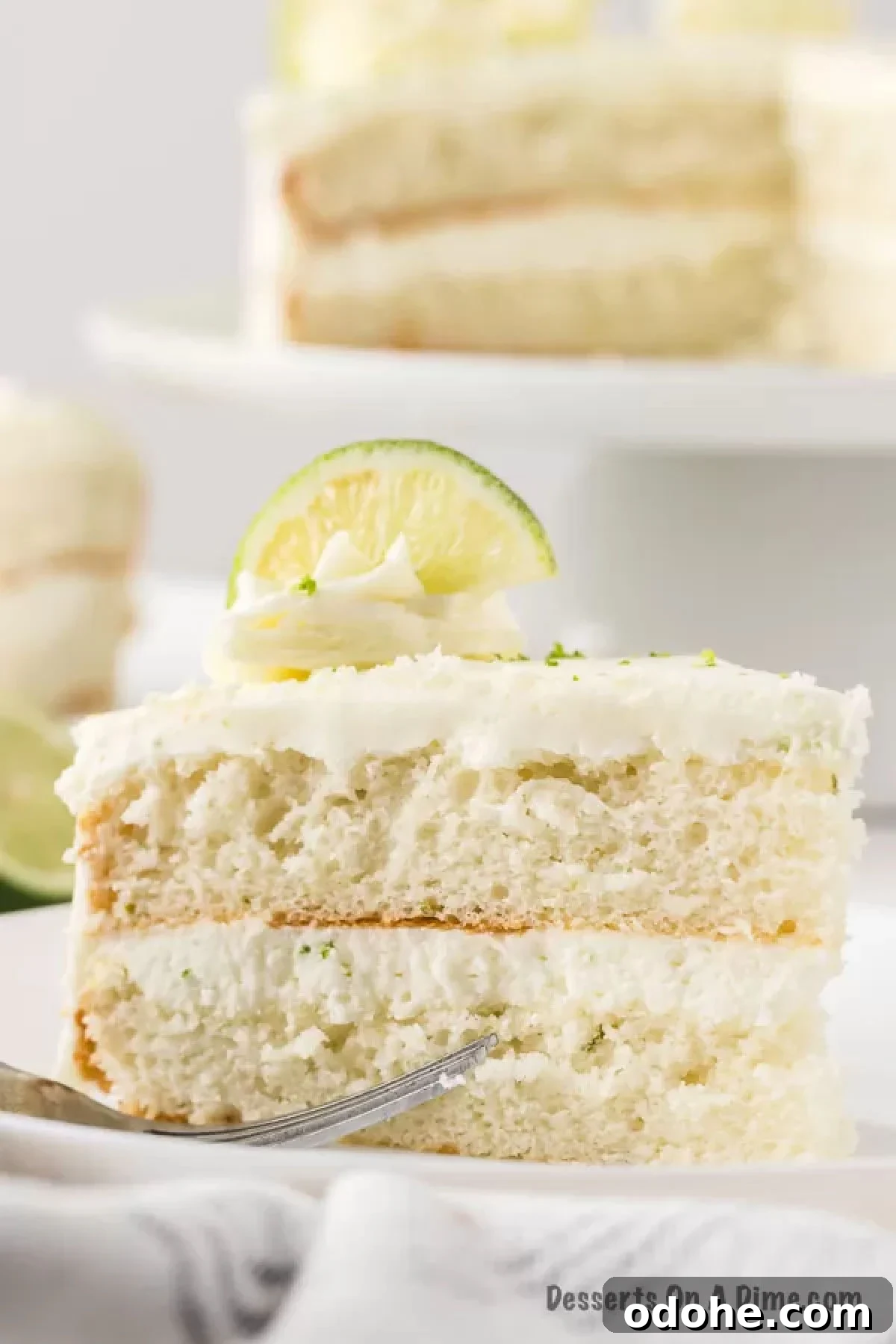 Lime Margarita Cake Recipe: Zesty Layer Cake with Tequila 5 Close up photo of cake slice on plate.