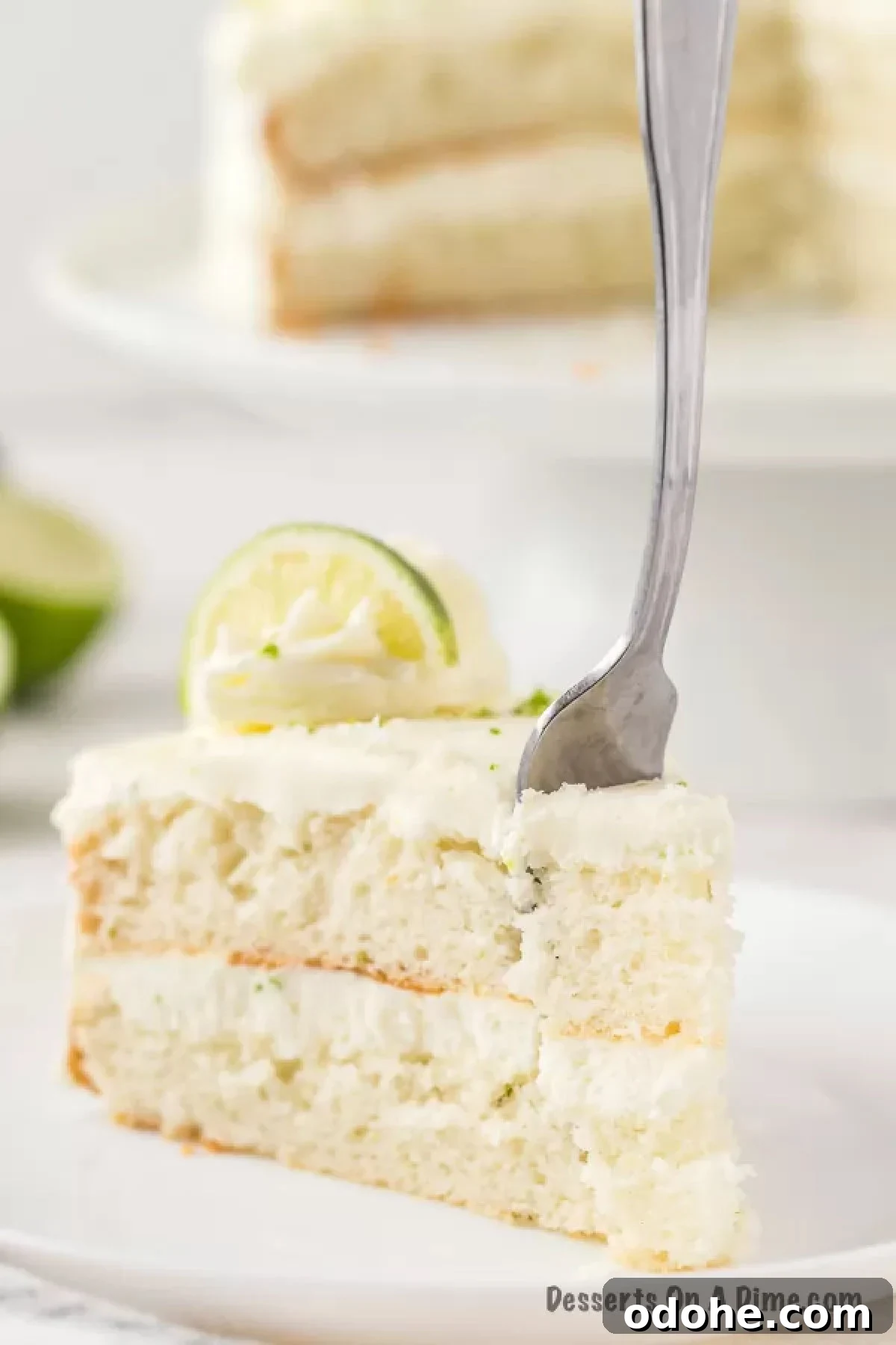 Lime Margarita Cake Recipe: Zesty Layer Cake with Tequila 4 Slice of cake with fork.