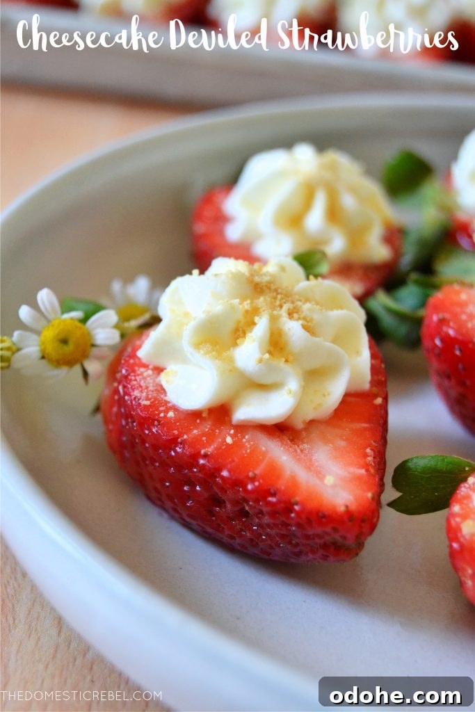 a cheesecake deviled strawberry on a white plate with a daisy