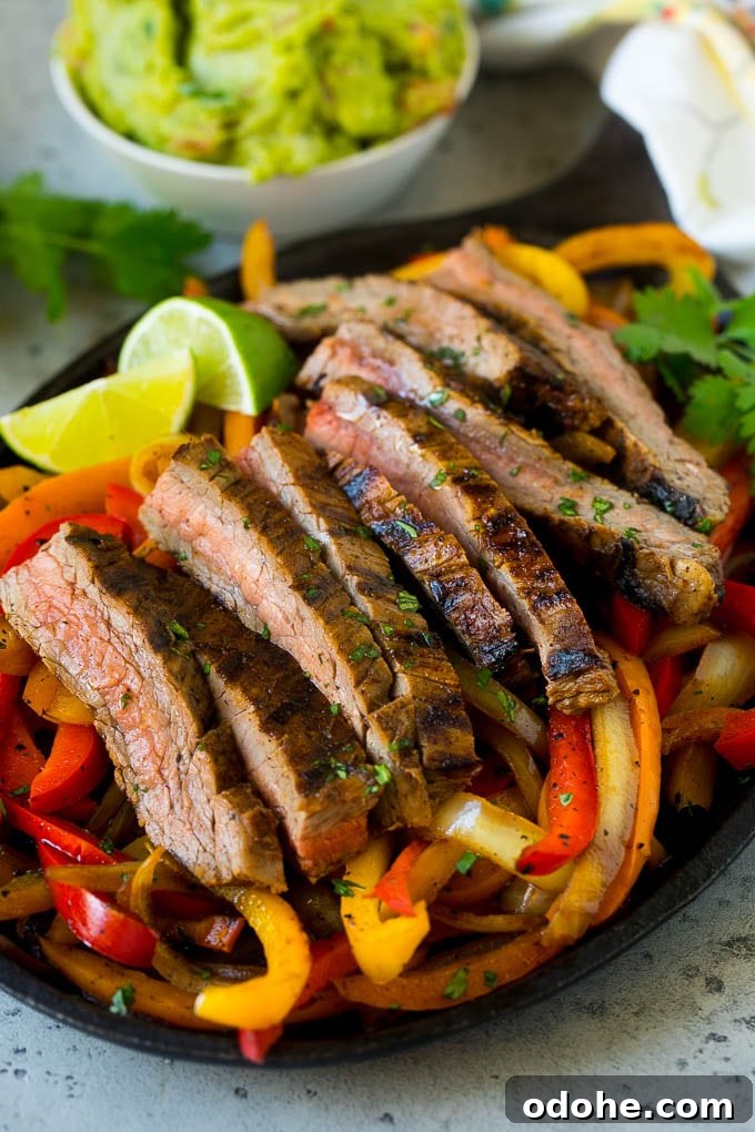 Steak Fajitas Recipe | Beef Fajitas | Steak Recipe #fajitas #steak #beef #mexicanfood #dinner #dinneratthezoo A skillet of steak fajitas with red and yellow peppers.