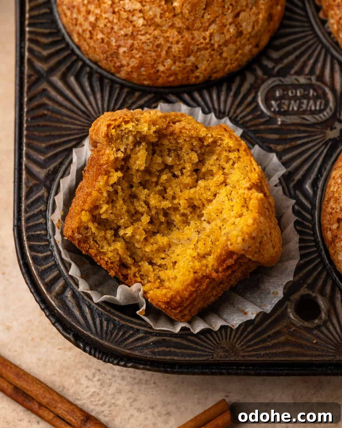 A gluten free pumpkin banana muffin with a bite taken out.