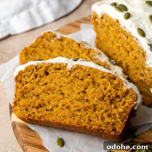 Sliced pumpkin bread on a wooden cutting board.