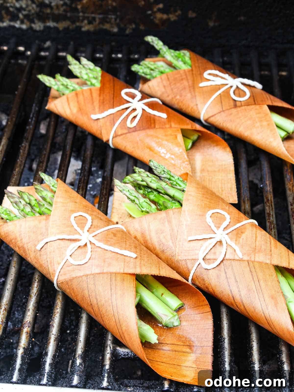 Cedar-Plank Grilled Salmon: Smoky Summer Recipe for Outdoor BBQ 4 Cedar wrapped salmon bundles on the grill