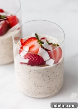 a cup of protein overnight oats topped with strawberries
