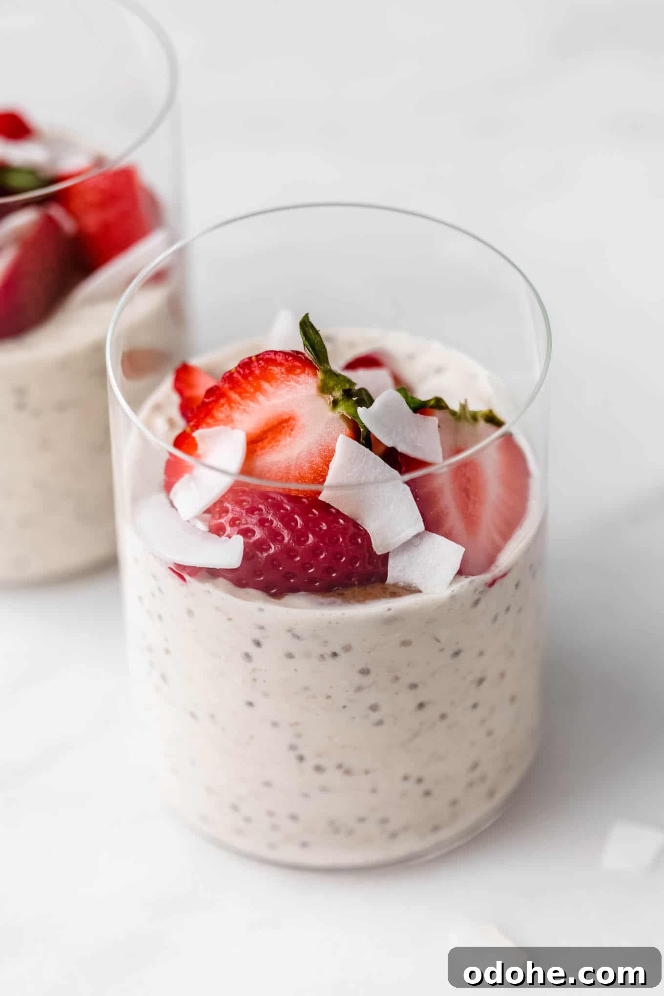 a cup of protein overnight oats topped with strawberries