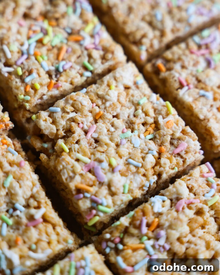 Vegan Rice Crispy Treat squares topped with colorful pastel sprinkles.