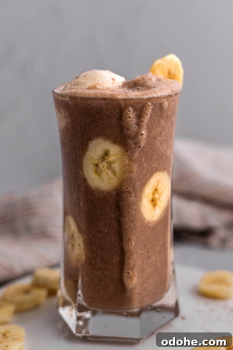 Clear glass filled with Magical Mocha Vegan Milkshake and banana slices.