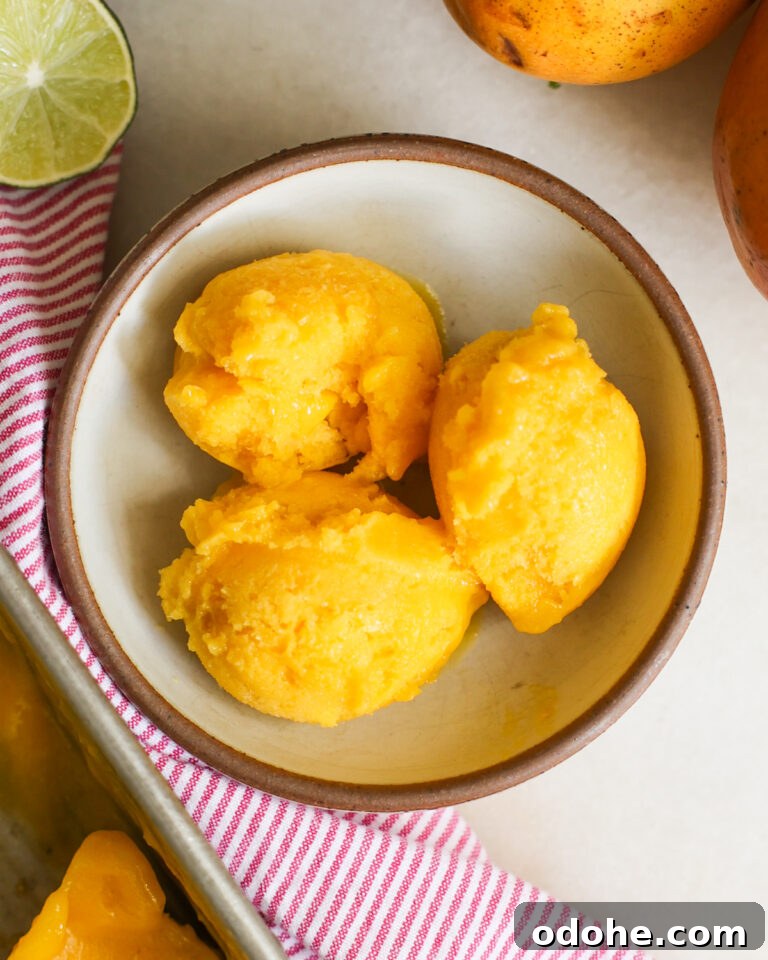 Three scoops of Mango Sorbet in a bowl.