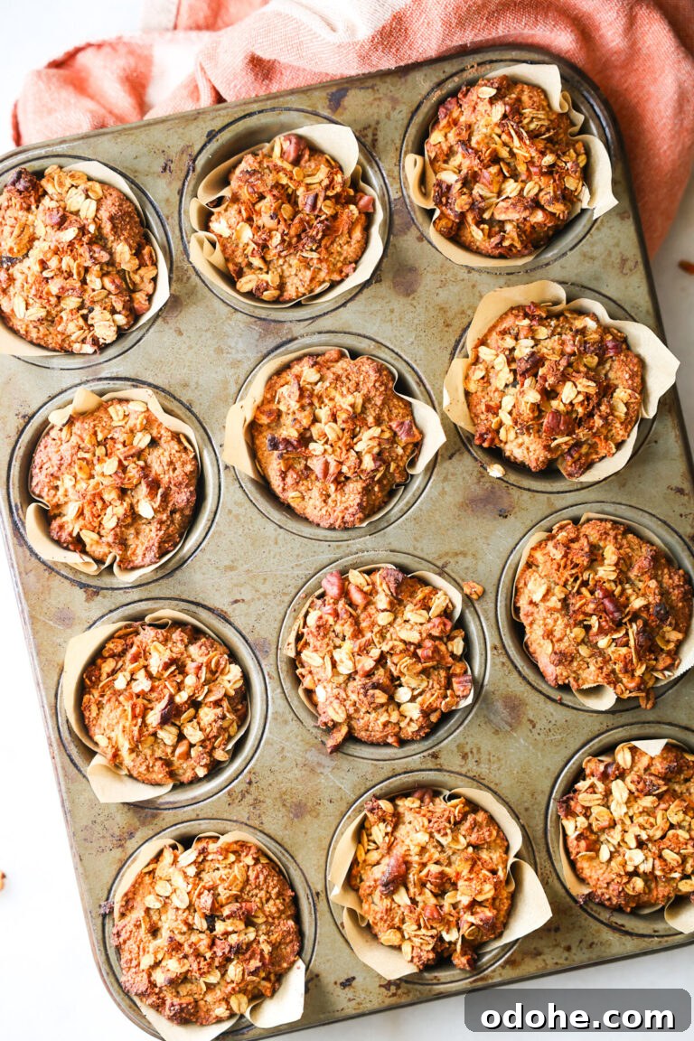 Twelve Oat Bran Muffins in a muffin pan.