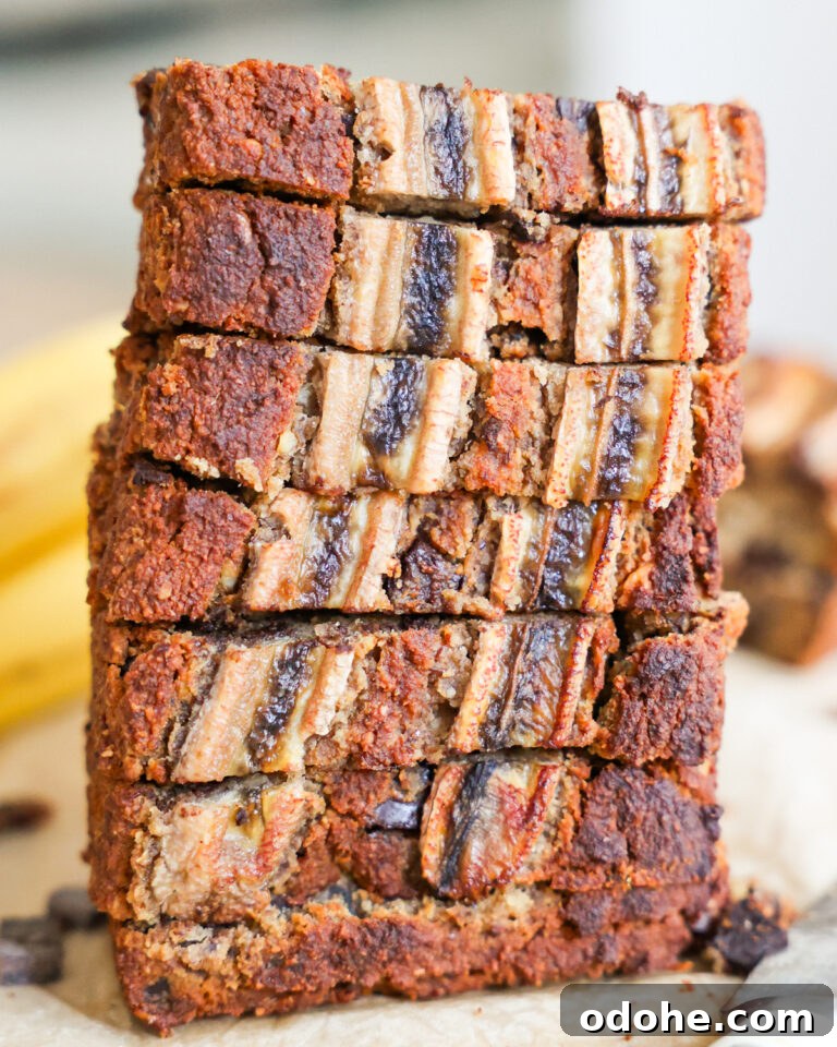 Loaf of sliced Almond Flour Banana Bread sitting on its end.