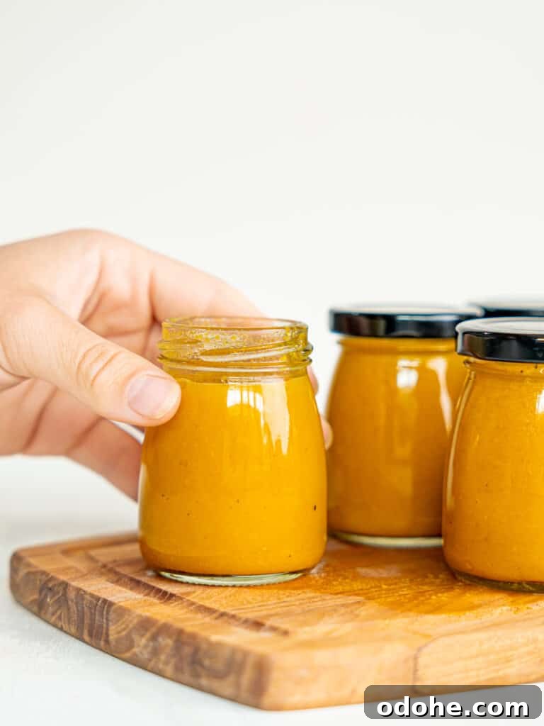 Anti-inflammatory immunity shots in small bottles. A hand is holding one of the bottles.