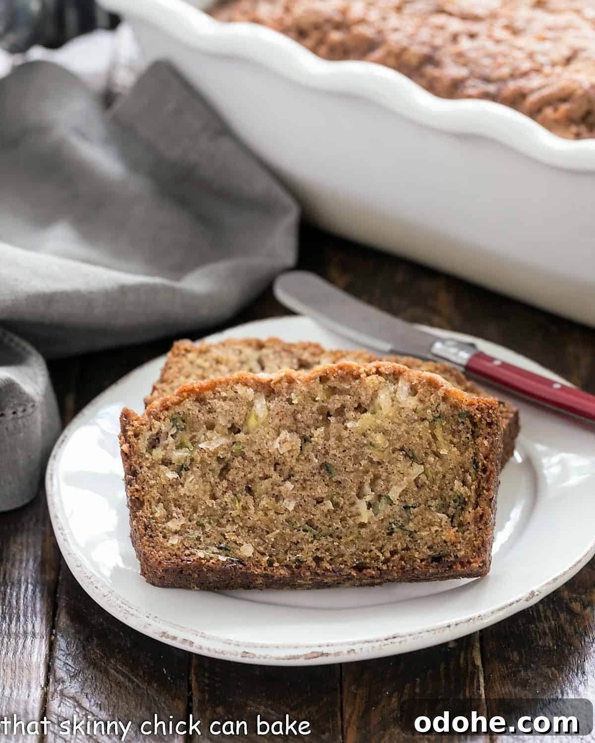 Pineapple Coconut Zucchini Quick Bread with Tropical Flavor 2 Slices of pineapple zucchini bread on a white ceramic platter.