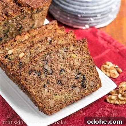 Pineapple Coconut Zucchini Bread - The ultimate summer quick bread with walnuts, pineapple and coconut! Slices of pinapple coconut zucchin bread on a white tray on a red napkin.