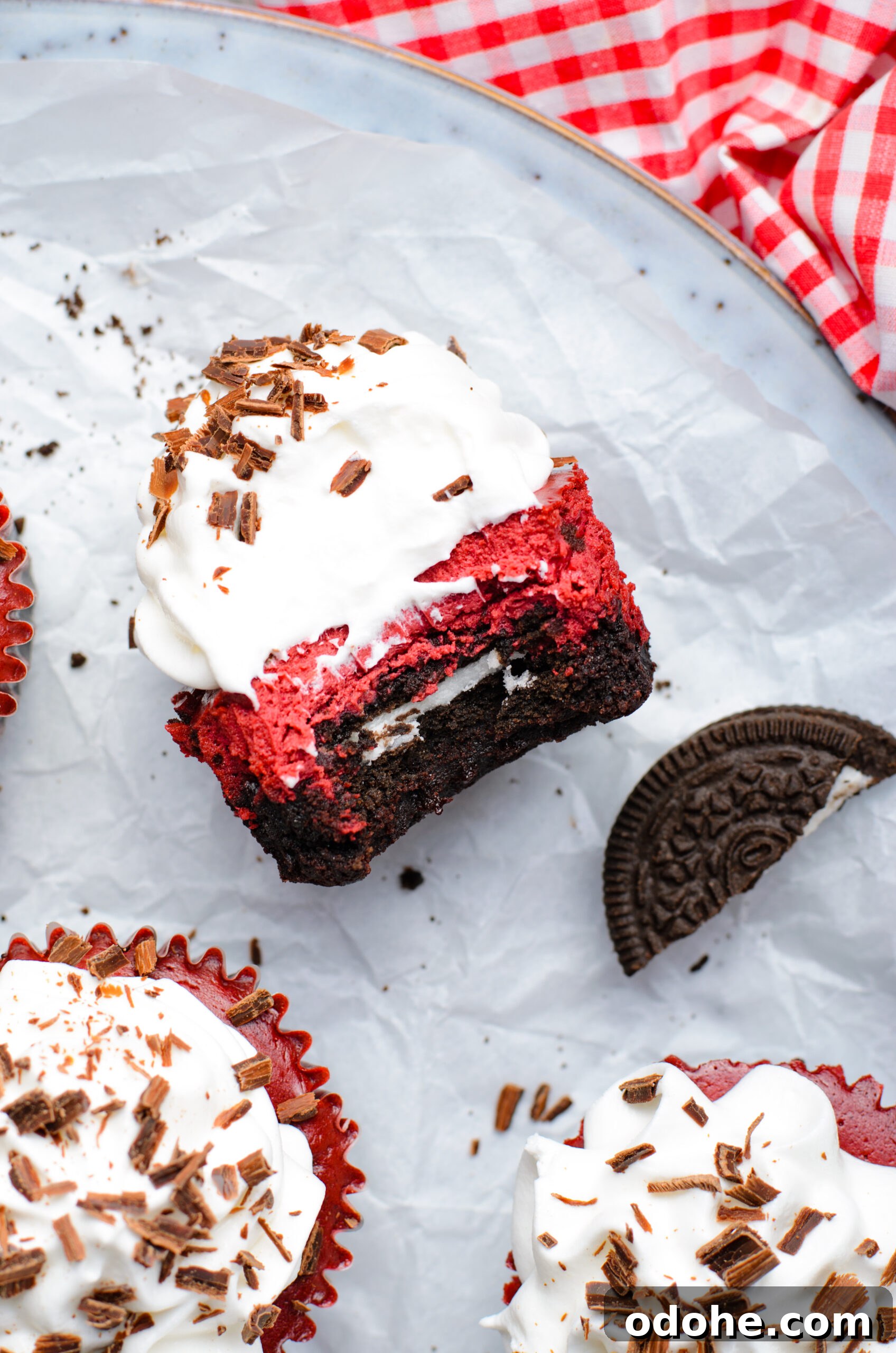 Mini Red Velvet Oreo Cheesecake Bites for Parties 18 Overhead view of a Mini Red Velvet Oreo Cheesecake on its side with a bite removed.