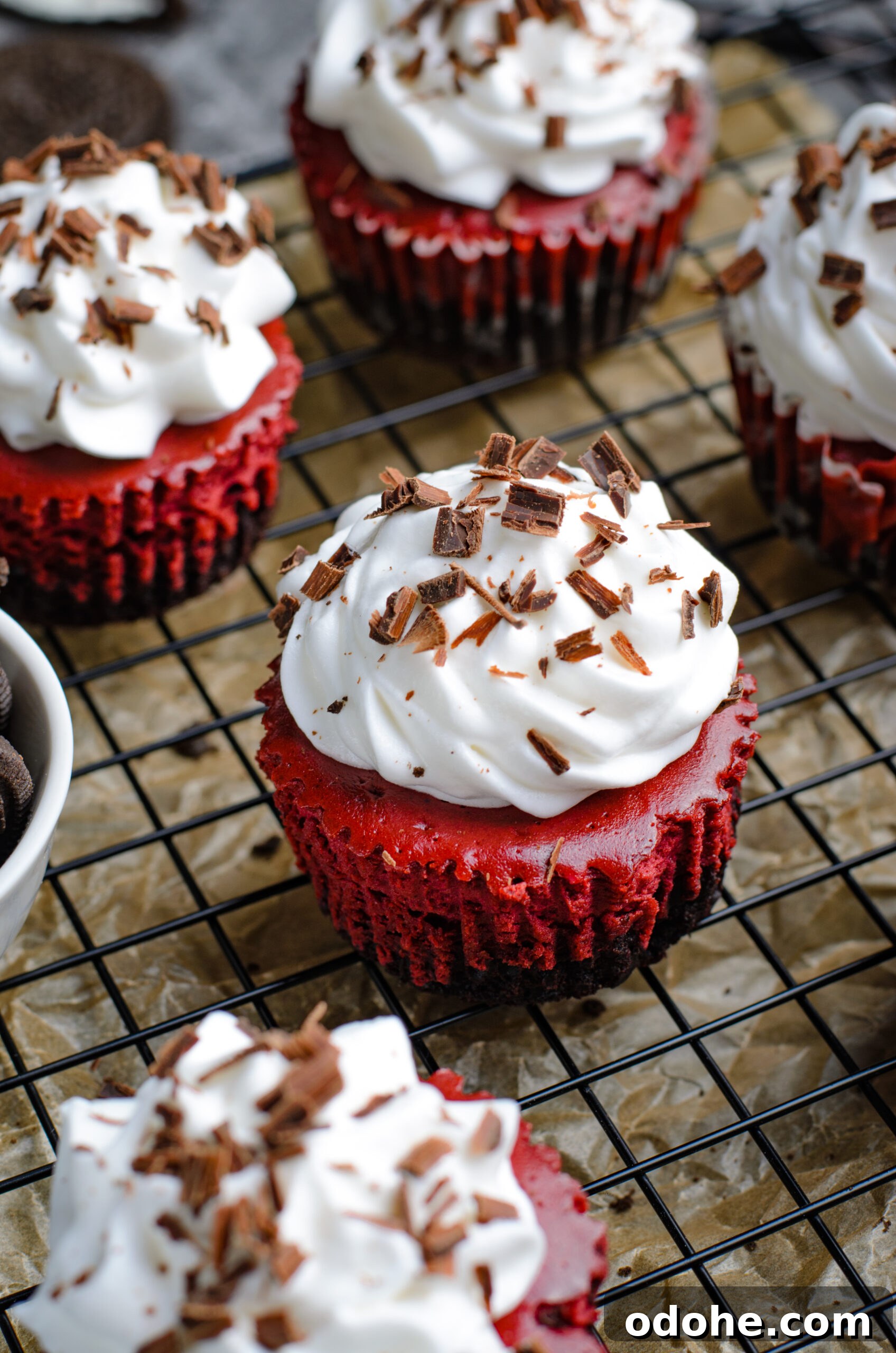 Mini Red Velvet Oreo Cheesecake Bites for Parties 4 Close up view of Mini Red Velvet Oreo Cheesecakes on a back wire rack.