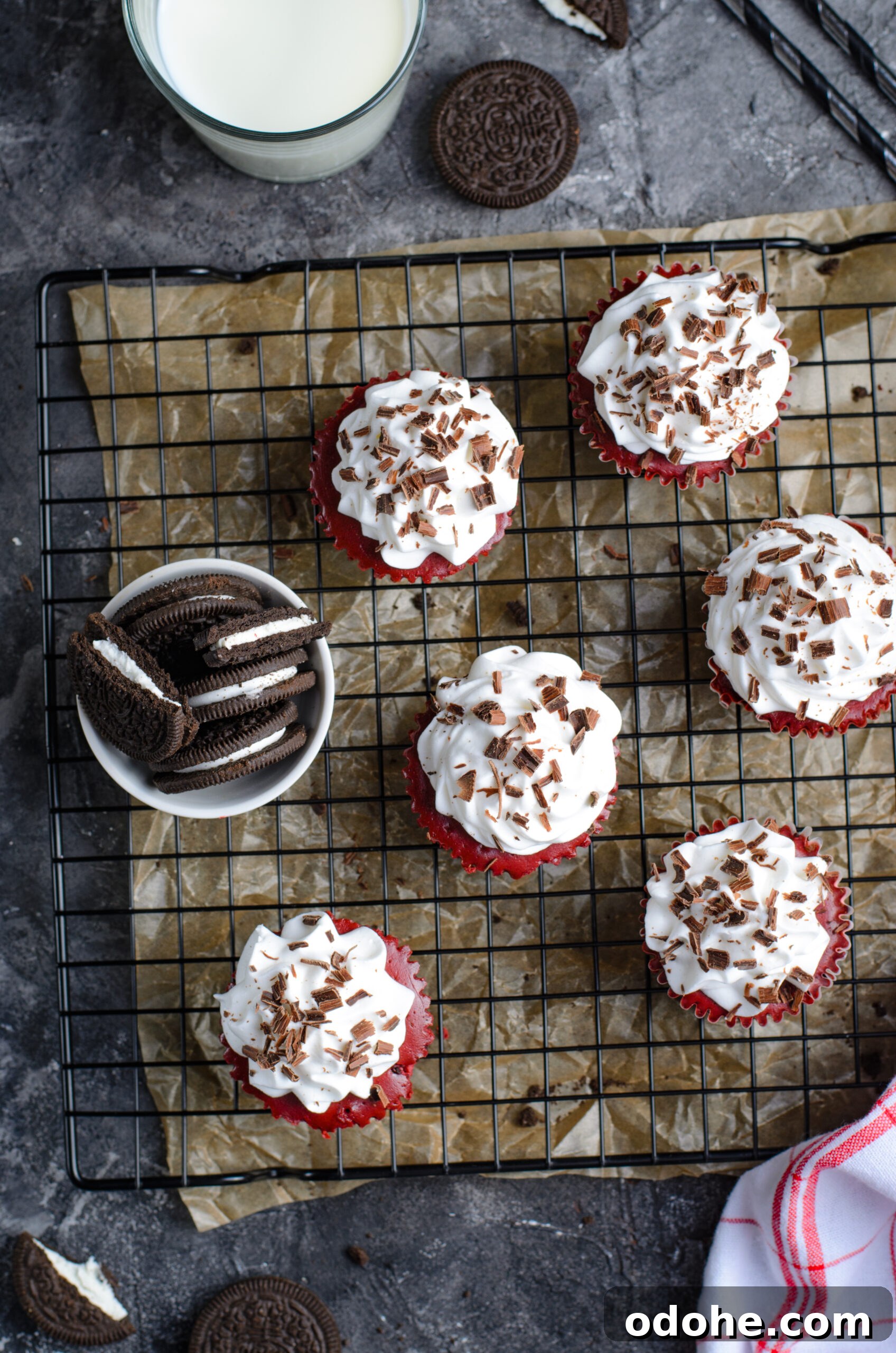Mini Red Velvet Oreo Cheesecake Bites for Parties 6 Overhead view of Mini Red Velvet Oreo Cheesecakes on a black wire rack.